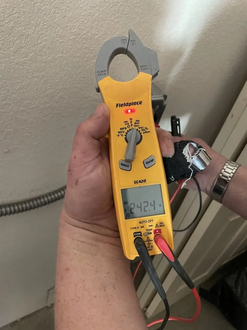 Voltage testing with clamp meter during Recessed Lighting Installation in South Russell